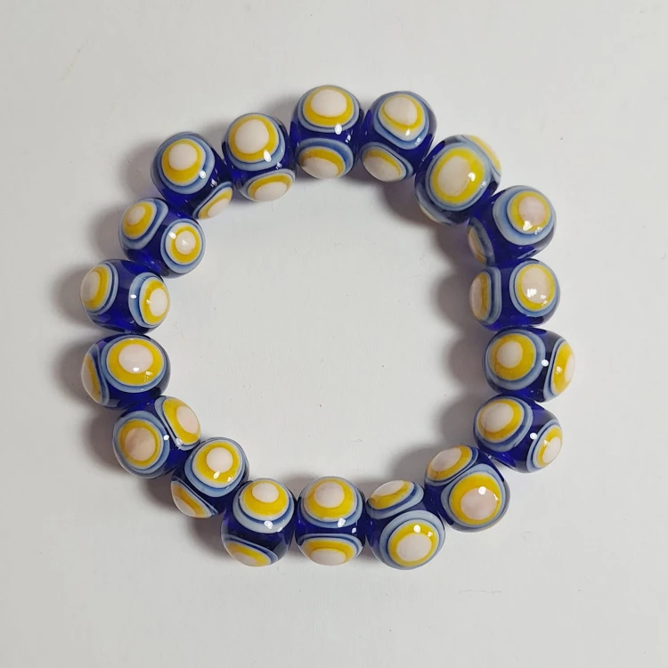 Szafirowe Słońce  ręcznie wykonana bransoletka  ze szkła artystycznego  lampwork płasko na podłodze